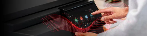 A close up of a man using the Synappx Cloud Print software installed on a printer